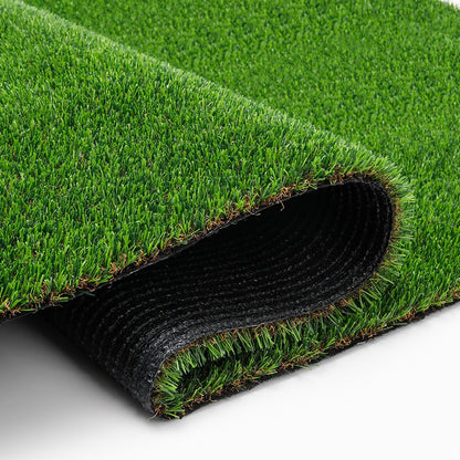 Folded artificial grass showing the green pile, cut edge and black backing.