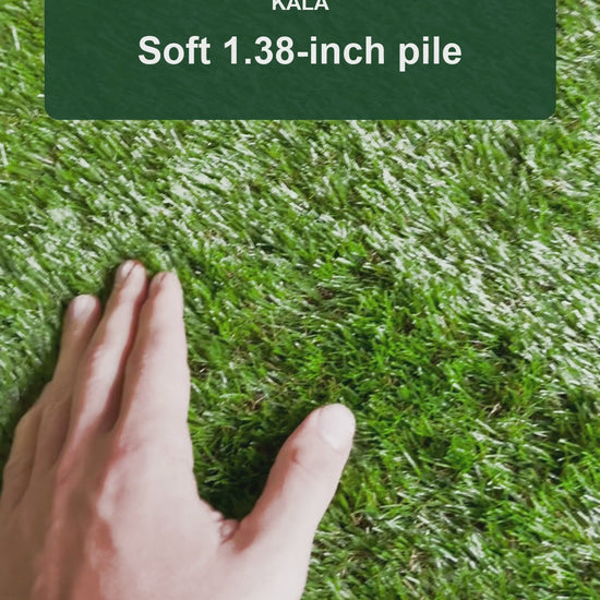 Real KALA artificial grass shown up close by hand, with 1.38-inch pile and 6.5 x 10 ft roll size.